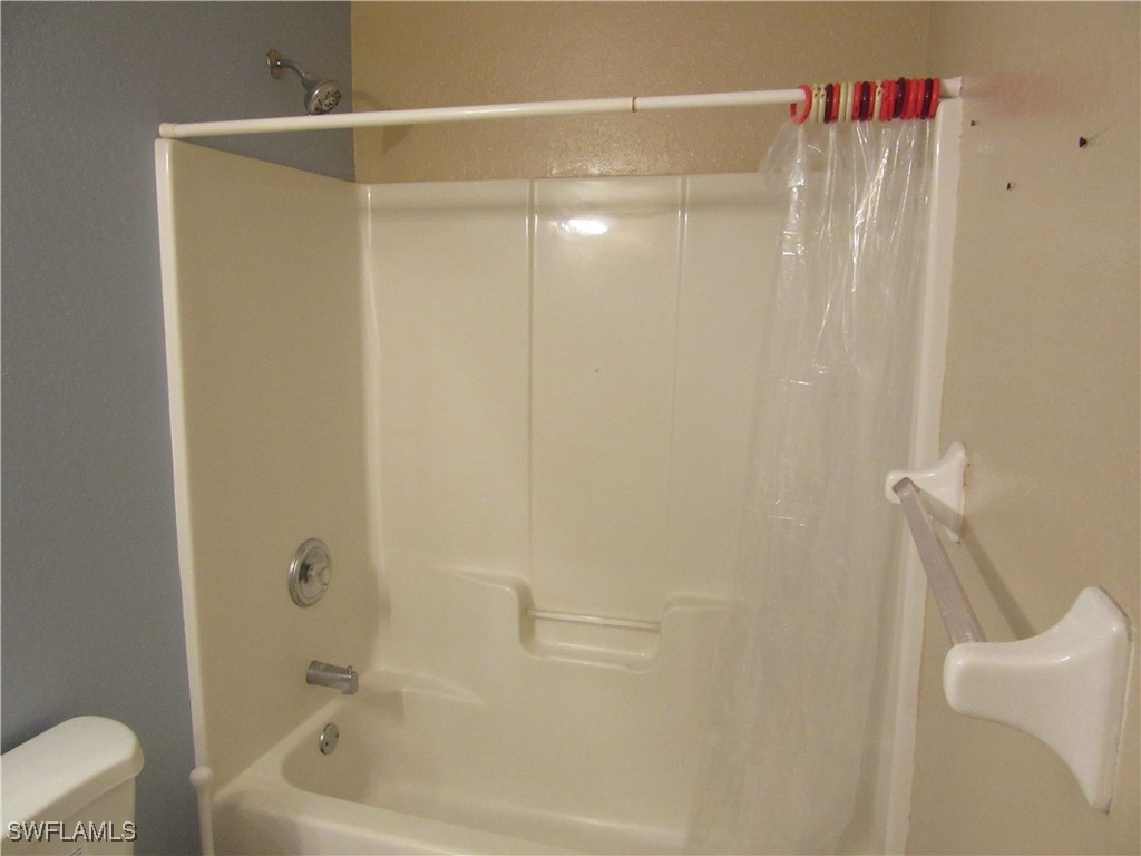 271 Southwest 4th Street, Unit 271 Cape Coral, FL 33991 - Photo 9 of 17 a bathroom with a shower and a tub