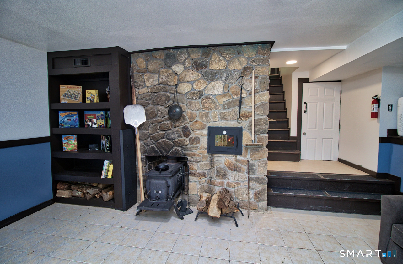 15 Lower Road North Canaan, CT 06018 - Photo 28 of 36 a living room with furniture a flat screen tv and a fireplace