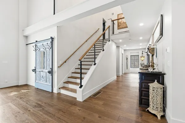 a view of entryway and hall with wooden floor