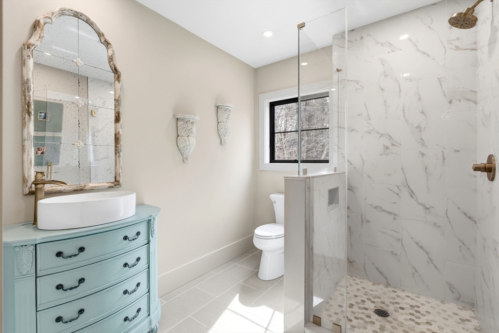 41 Myrtle Street Norfolk, MA 02056 - Photo 35 of 42 a bathroom with a sink a toilet and shower