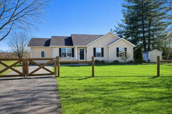 a view of a house with a yard and sitting area