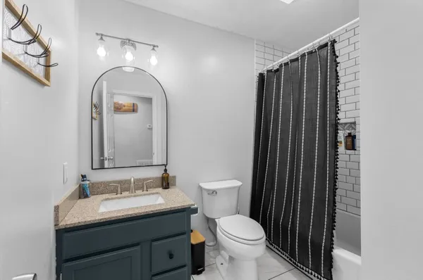 a bathroom with a toilet sink and mirror