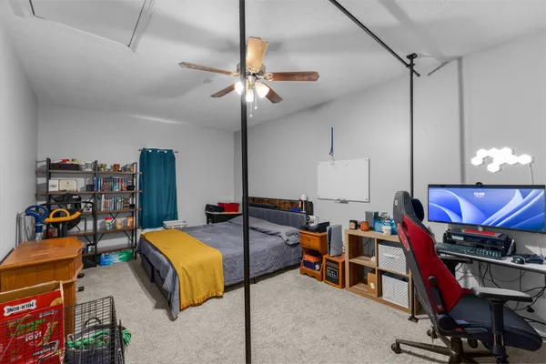 a bed room with a bed and a chair