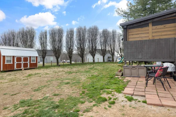 a view of a backyard with a table and chairs