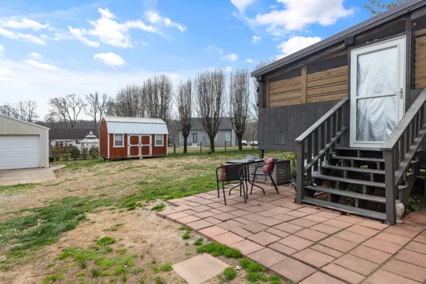 a view of a house with backyard porch and sitting area