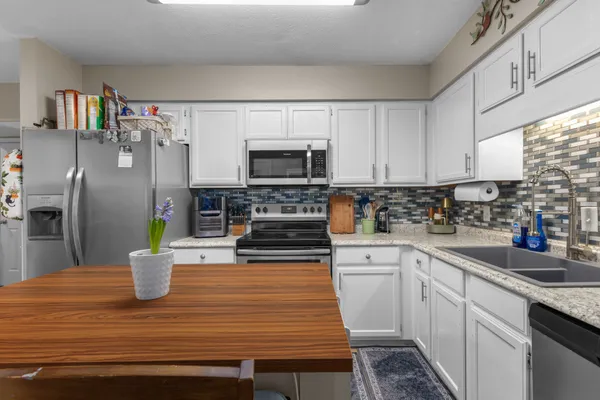 a kitchen with a refrigerator and a sink