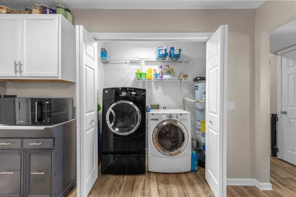 a utility room with sink dryer and washer