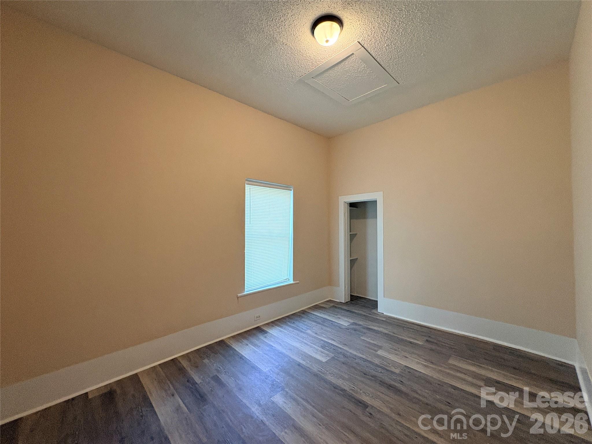 1109 6th Street, Unit B Lancaster, SC 29720 - Photo 13 of 22 an empty room with wooden floor and windows