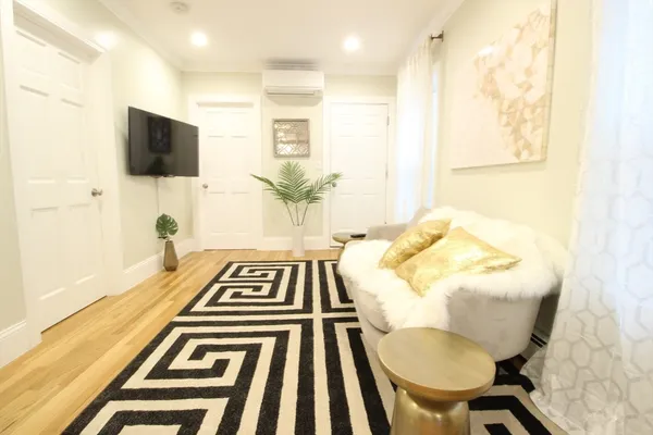 a view of a living room with furniture and a flat screen tv