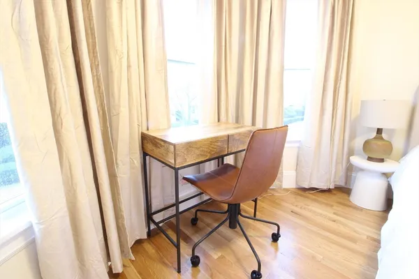 a view of a room with furniture and a window