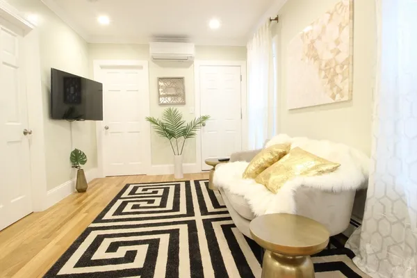 a spacious bedroom with a bed and a flat screen tv