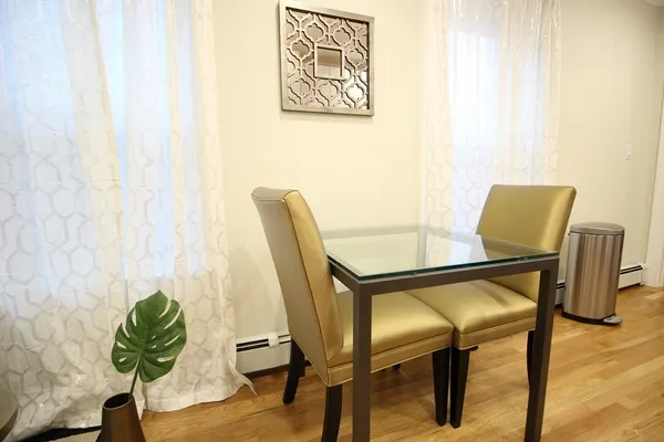 a view of a dining room with furniture and wooden floor