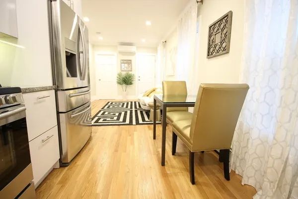 a view of kitchen with furniture and wooden floor