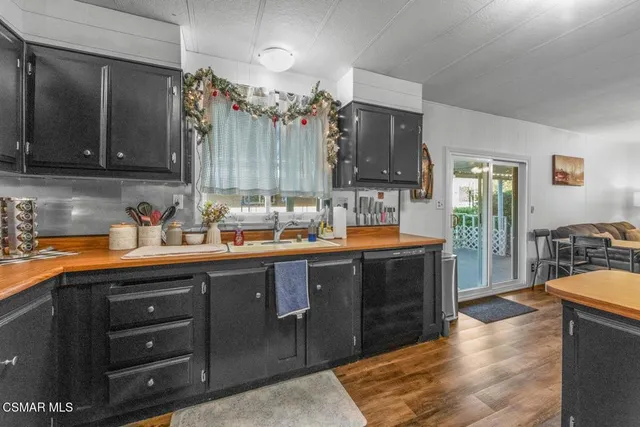 a kitchen with stainless steel appliances granite countertop a sink and cabinets