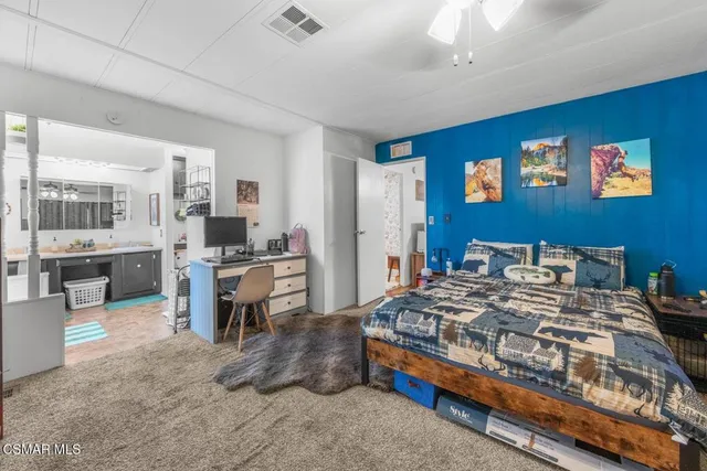 a bedroom with a bed and wooden furniture