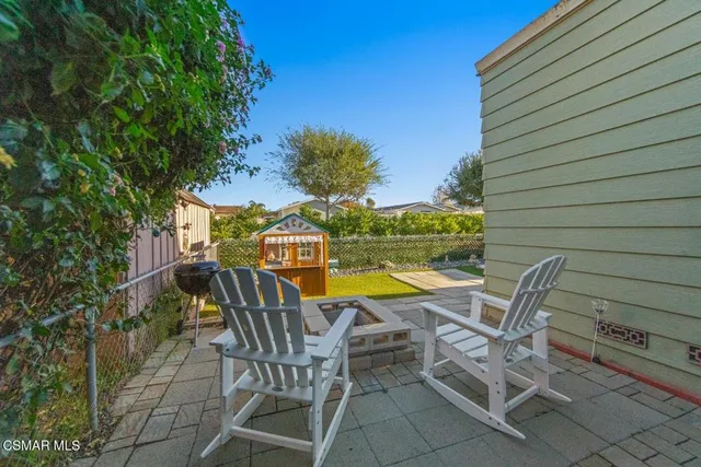 a view of a chairs and table in the patio