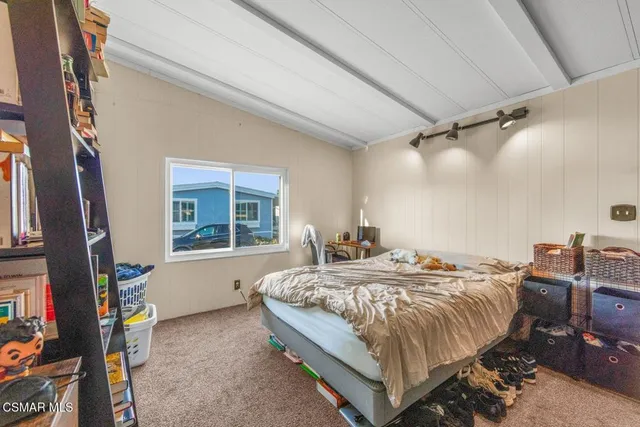 a bed sitting in a room next to a window