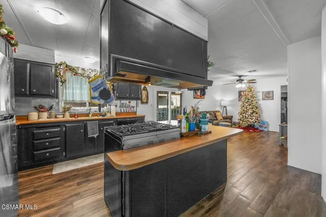 a kitchen with stainless steel appliances granite countertop a sink and cabinets