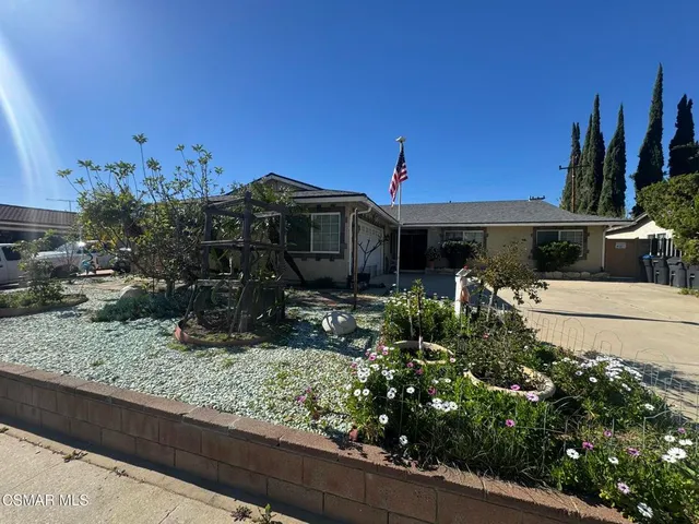 a view of a workspace with furniture and wooden floor