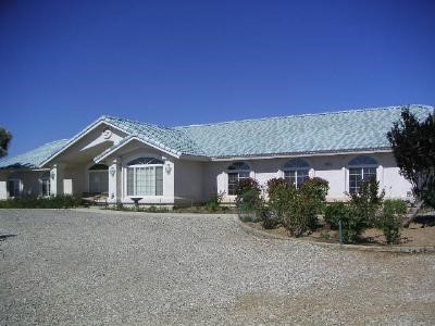 10442 Cordero Road Phelan, CA 92371 - Photo 1 of 1 a front view of a house with a yard