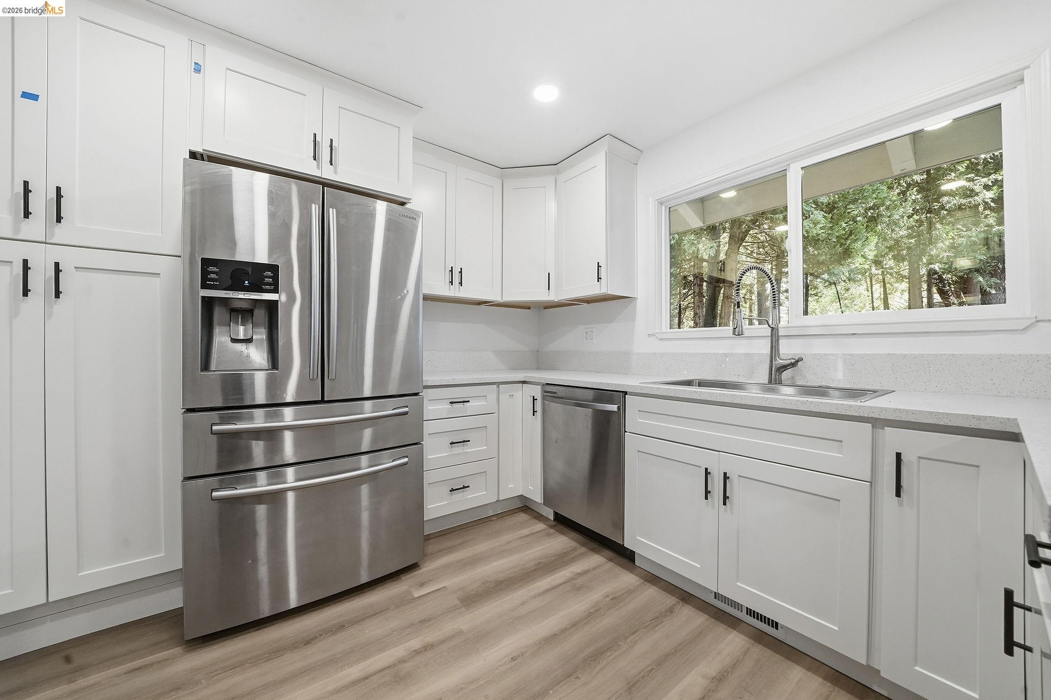 23656 Lightning Pioneer, CA 95666 - Photo 2 of 23 Kitchen with stainless steel appliances, white cabinetry, light wood-style flooring, recessed lighting, and light stone counters