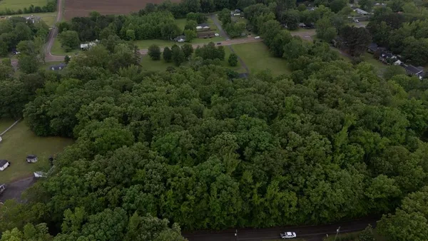 an aerial view of a house with a yard