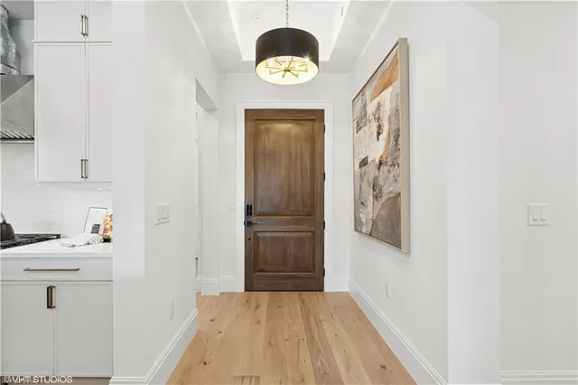 a bathroom with a sink a light fixture and a window