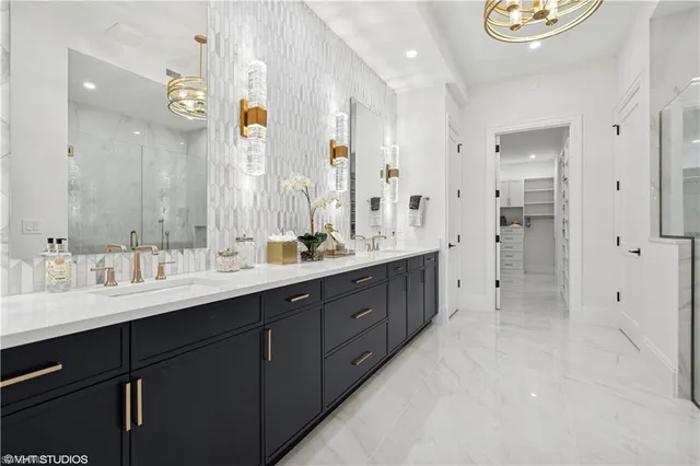 a spacious bathroom with a double vanity sink mirror and shower