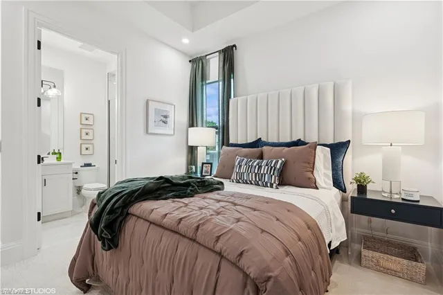 a bedroom with a bed and a lamp