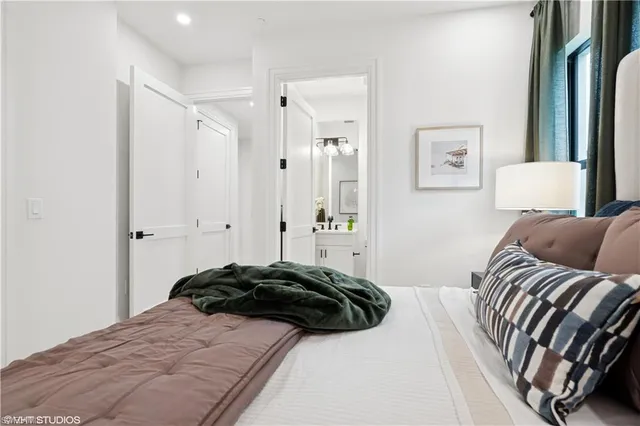 a bedroom with a bed and a painting