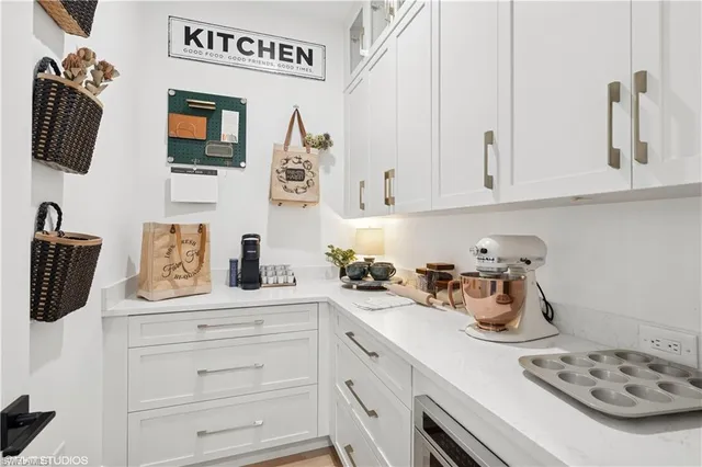 a kitchen with cabinets and window