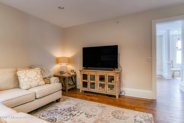 a view of a dining room with furniture and wooden floor