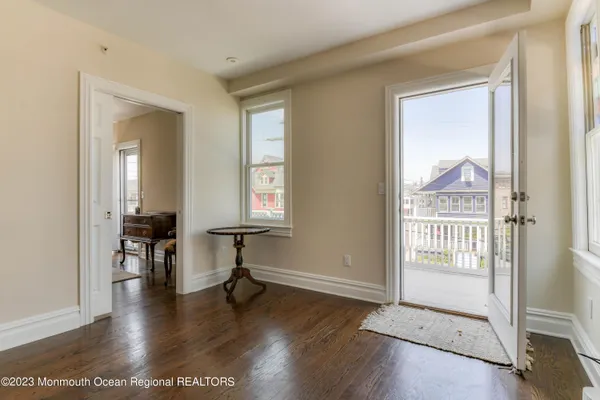 a view of a hallway with wooden floor