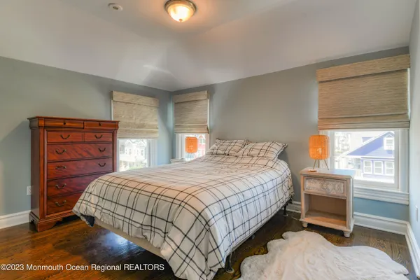 a living room with furniture a flat screen tv and a window