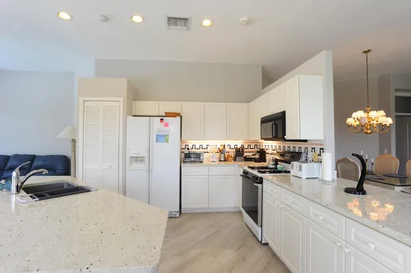 a kitchen with refrigerator and stove
