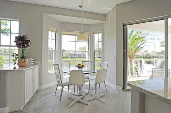 a view of a dining room with furniture and chandelier