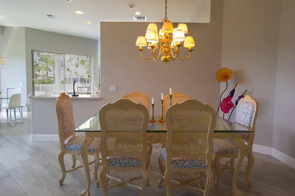 a view of a dining room with furniture wooden floor and chandelier