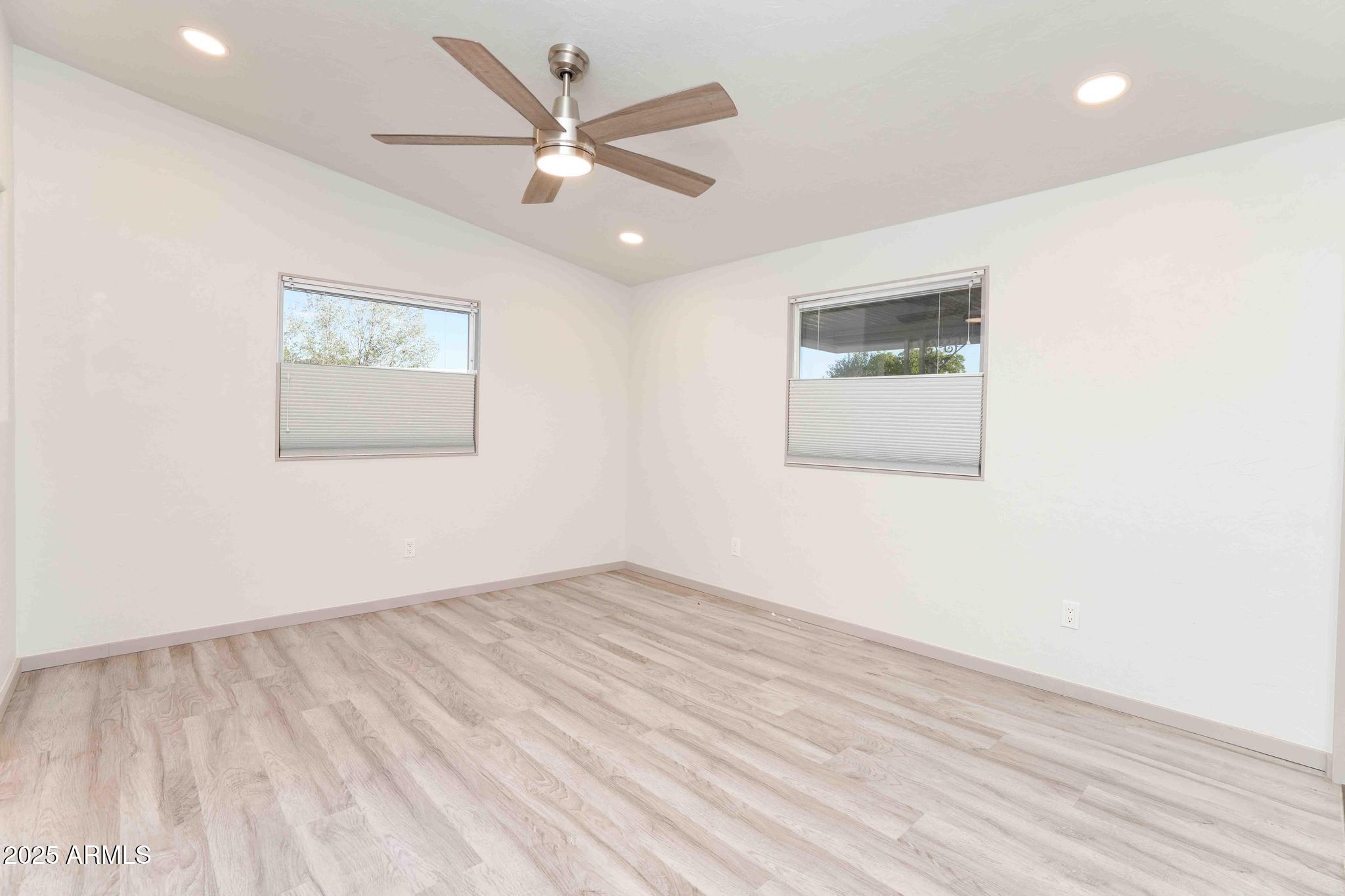 6770 West State Rte 89A, Unit 15 Sedona, AZ 86336 - Photo 15 of 27 an empty room with wooden floor and windows