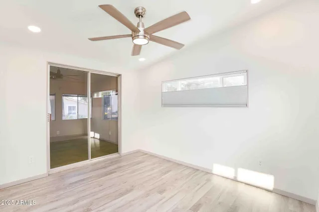 an empty room with wooden floor and door