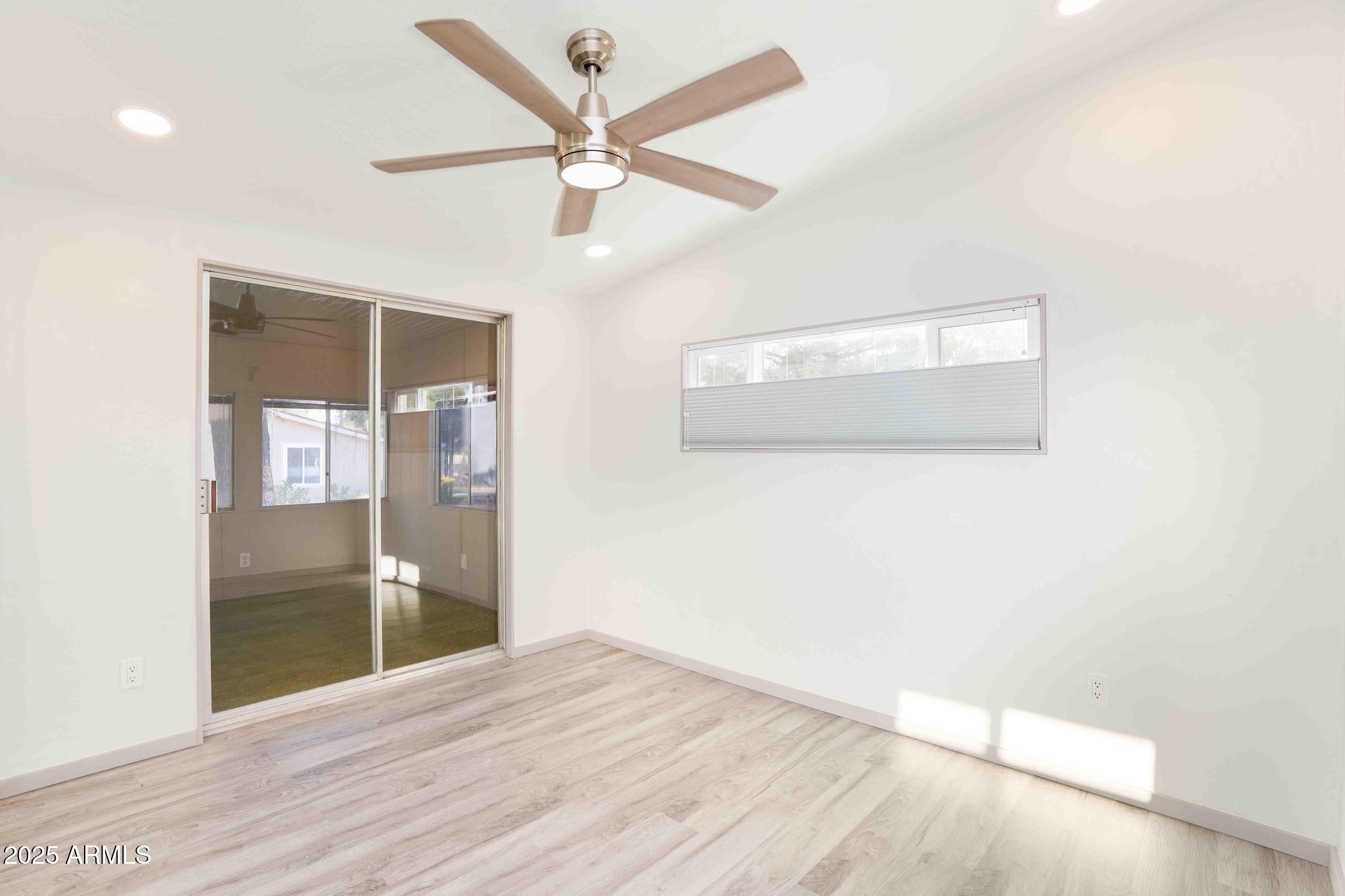 6770 West State Rte 89A, Unit 15 Sedona, AZ 86336 - Photo 18 of 27 an empty room with wooden floor and door