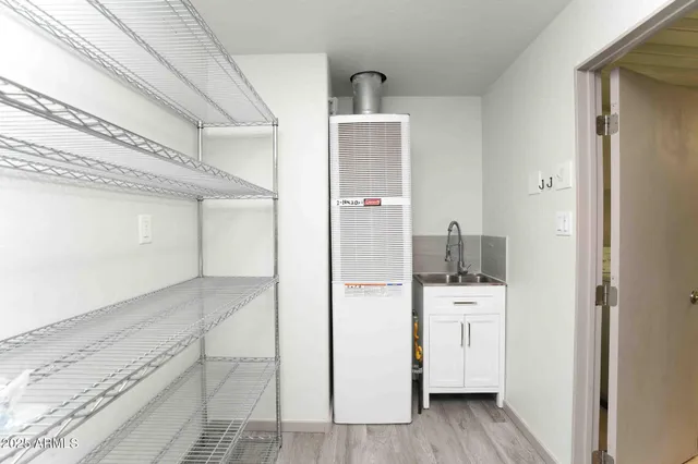 a kitchen with a refrigerator and a stove top oven