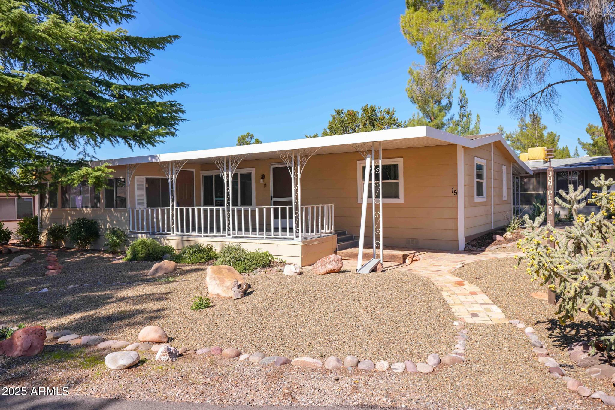 6770 West State Rte 89A, Unit 15 Sedona, AZ 86336 - Photo 27 of 27 a front view of a house with a yard and garage