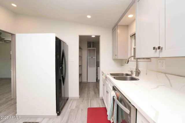 a kitchen with a sink a stove and a refrigerator