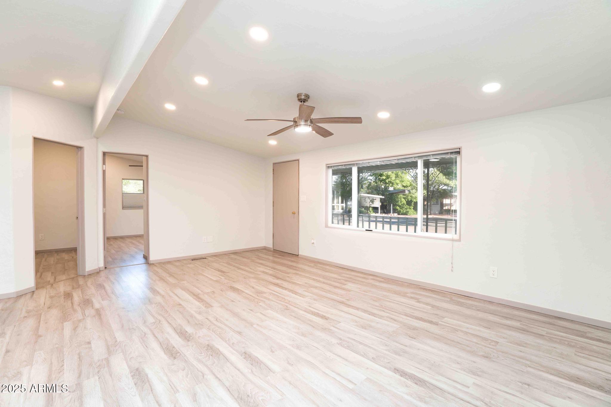 6770 West State Rte 89A, Unit 15 Sedona, AZ 86336 - Photo 9 of 27 a view of an empty room with wooden floor and a window