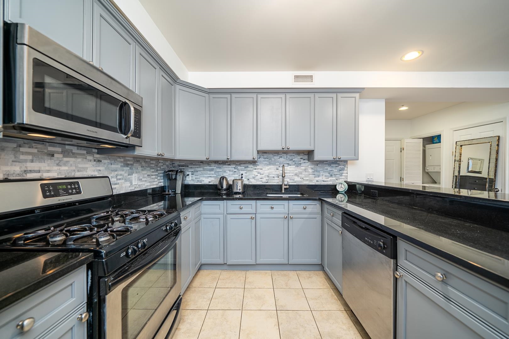 650 2nd Street, Unit 2K Hoboken, NJ 07030 - Photo 12 of 23 a kitchen with stainless steel appliances granite countertop a stove microwave and sink