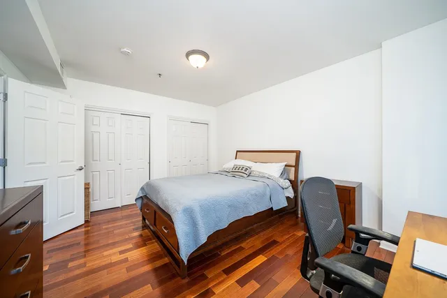 a bedroom with a bed and a chair