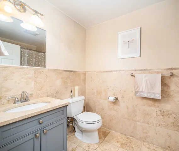 a bathroom with a toilet sink and mirror