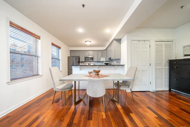 a view of a dining room with furniture and wooden floor