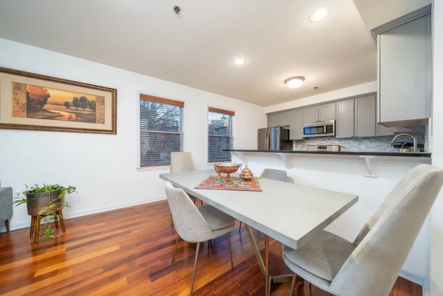 a view of a dining room with furniture and wooden floor