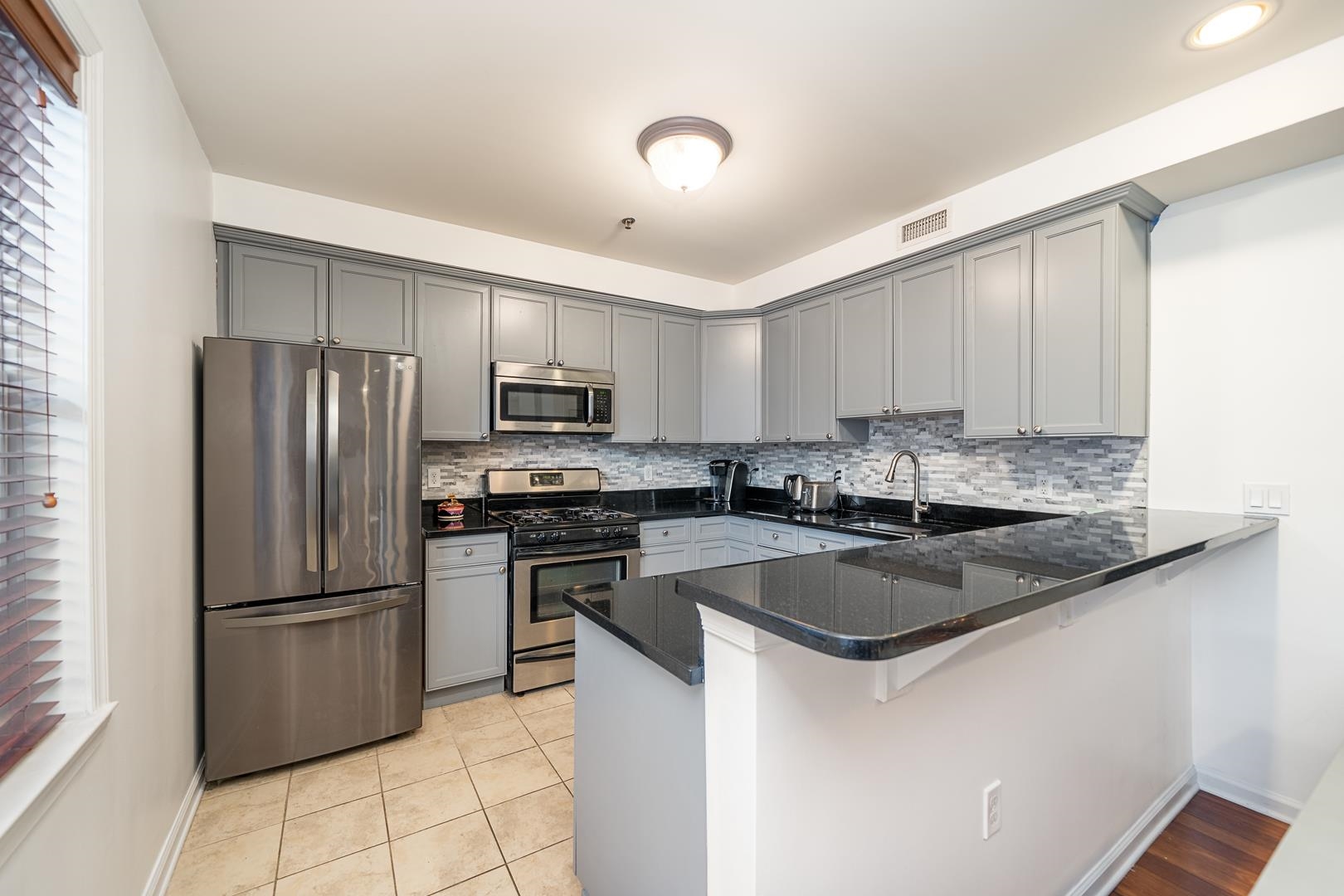 650 2nd Street, Unit 2K Hoboken, NJ 07030 - Photo 10 of 23 a kitchen with granite countertop a refrigerator and a sink